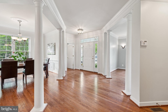 6 Crawford Ln, Stafford, VA 22556 - entryway with visible vents, crown molding, decorative columns, wood finished floors, and a chandelier