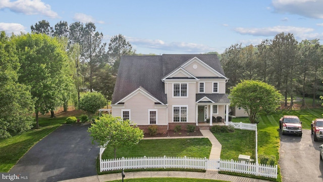 6 Crawford Ln, Stafford, VA 22556 - traditional-style home with a fenced front yard, a porch, a front lawn, and aphalt driveway