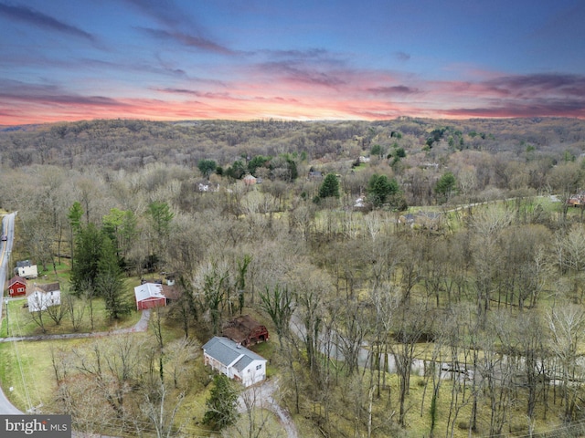 birds eye view of property featuring a wooded view