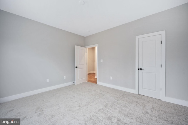 unfurnished bedroom featuring baseboards and carpet