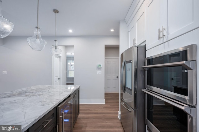 kitchen featuring wine cooler, light stone countertops, dark wood-style floors, white cabinets, and appliances with stainless steel finishes