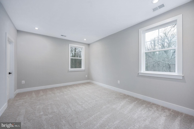 carpeted empty room with recessed lighting, baseboards, and visible vents