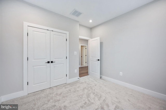 unfurnished bedroom featuring visible vents, baseboards, a closet, carpet, and recessed lighting