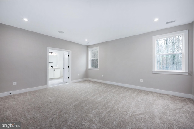 unfurnished bedroom with visible vents, recessed lighting, carpet, and baseboards