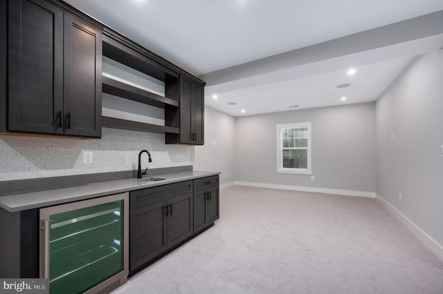 kitchen with tasteful backsplash, open shelves, a sink, baseboards, and wine cooler