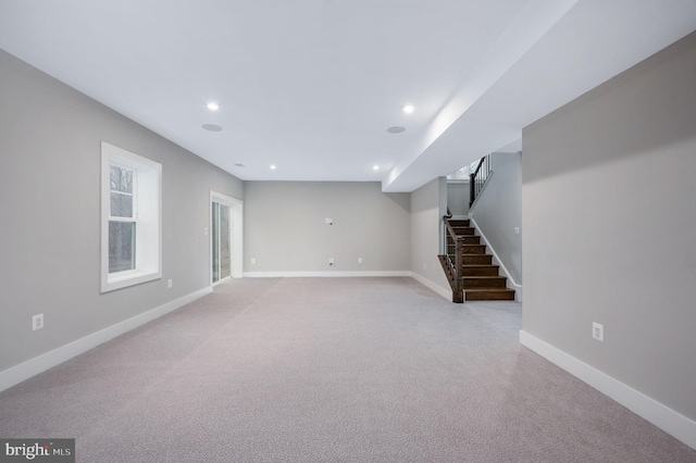 below grade area with carpet flooring, recessed lighting, baseboards, and stairs