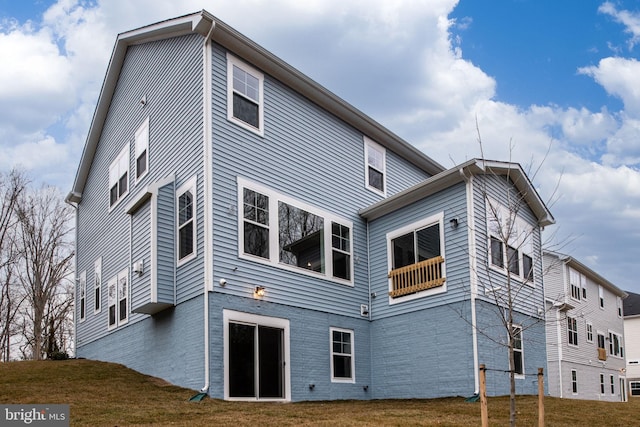 rear view of property with a yard