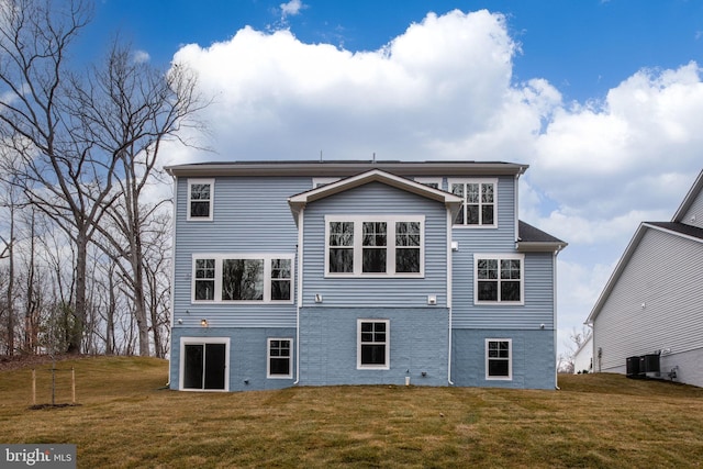 back of house featuring a lawn and central AC
