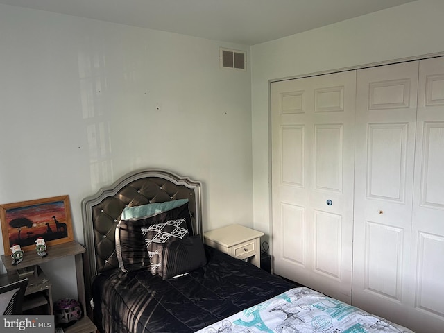 bedroom featuring visible vents and a closet