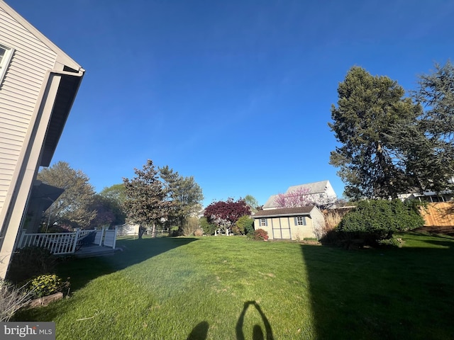 view of yard with a wooden deck and an outdoor structure