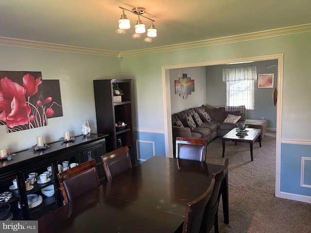 dining space featuring baseboards, ornamental molding, and carpet