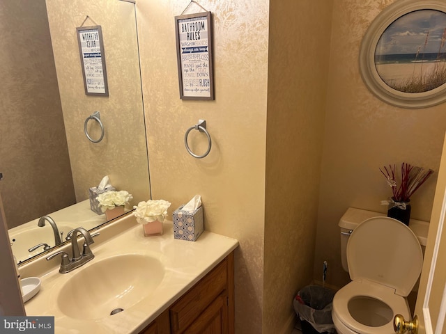 half bathroom featuring toilet and vanity