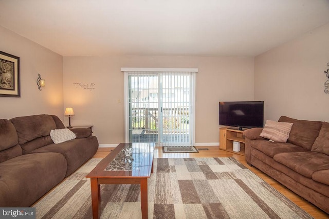 living room featuring wood finished floors and baseboards