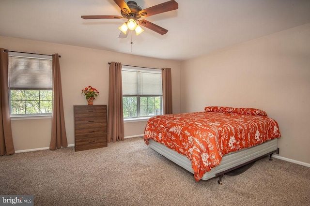 bedroom featuring baseboards, a ceiling fan, and carpet floors