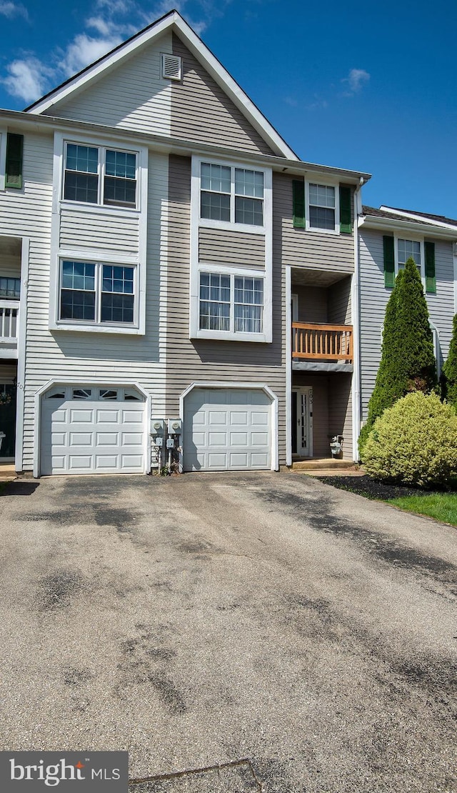 multi unit property with driveway and a garage