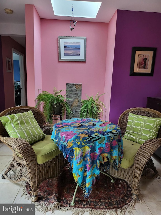 tiled dining area with a skylight