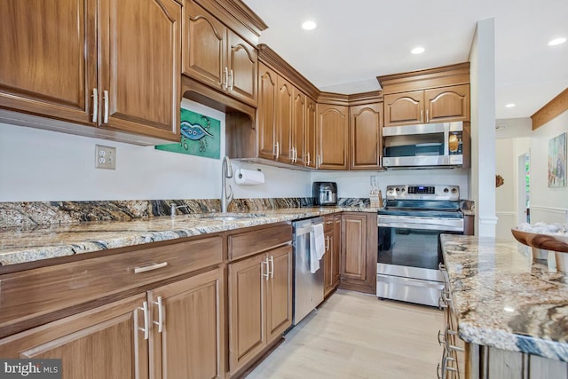 611 Cypress Rd, Severna Park, MD 21146 - kitchen with light stone counters, stainless steel appliances, recessed lighting, and a sink
