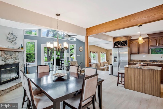 611 Cypress Rd, Severna Park, MD 21146 - dining space with an inviting chandelier, light wood-style flooring, lofted ceiling with beams, and a stone fireplace