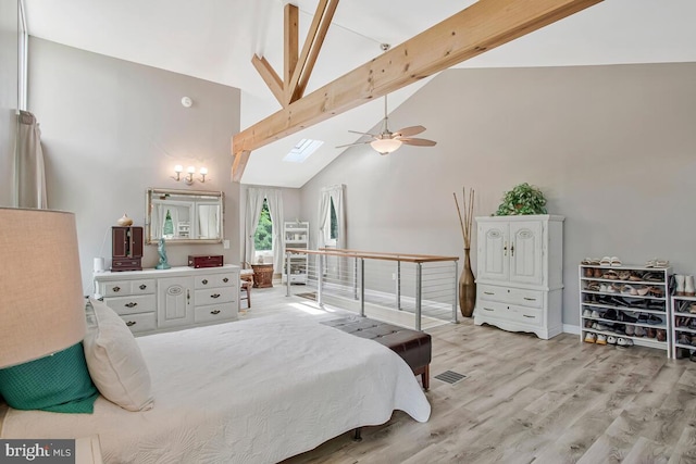 611 Cypress Rd, Severna Park, MD 21146 - bedroom featuring high vaulted ceiling, beam ceiling, a skylight, light wood-type flooring, and visible vents