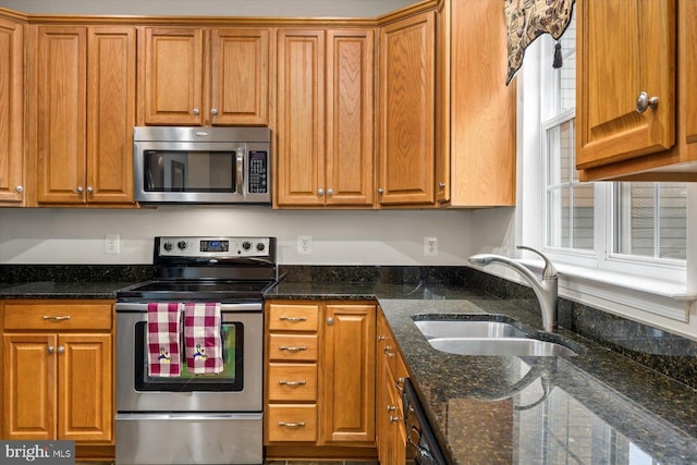 1201 Preserve Ln, Fredericksburg, VA 22401 - kitchen with appliances with stainless steel finishes, dark stone countertops, brown cabinetry, and a sink