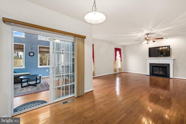 1201 Preserve Ln, Fredericksburg, VA 22401 - unfurnished living room featuring a fireplace with flush hearth, visible vents, hardwood / wood-style floors, baseboards, and a ceiling fan
