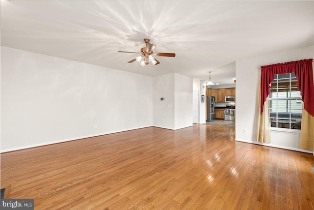 1201 Preserve Ln, Fredericksburg, VA 22401 - unfurnished living room with baseboards, hardwood / wood-style flooring, and ceiling fan