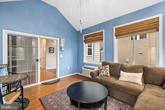 1201 Preserve Ln, Fredericksburg, VA 22401 - living area with visible vents, baseboards, an AC wall unit, vaulted ceiling, and wood finished floors