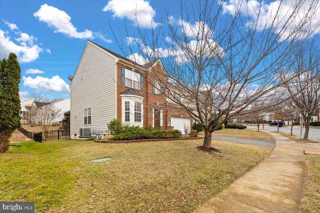 1201 Preserve Ln, Fredericksburg, VA 22401 - view of front of house with fence, cooling unit, brick siding, and a front lawn
