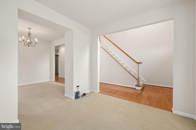 1201 Preserve Ln, Fredericksburg, VA 22401 - unfurnished living room with an inviting chandelier, baseboards, and carpet floors