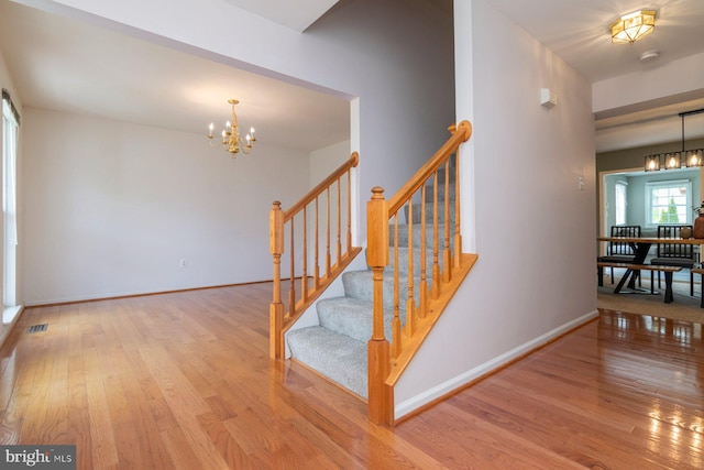 4600 Forge Acre Dr, Perry Hall, MD 21128 - staircase with an inviting chandelier, baseboards, wood finished floors, and visible vents