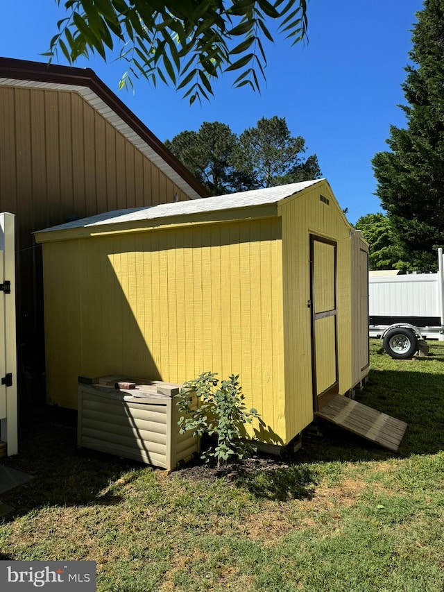 view of shed featuring fence