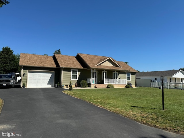 ranch-style home featuring a garage, aphalt driveway, fence, a front yard, and a porch
