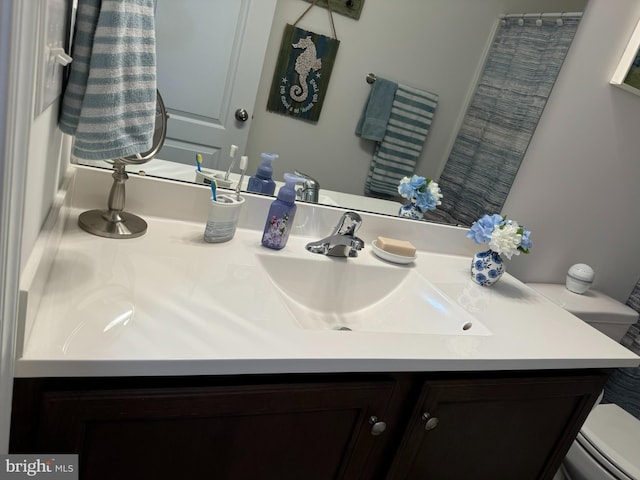 full bathroom featuring vanity and toilet