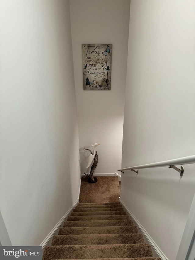 stairs with carpet flooring and baseboards
