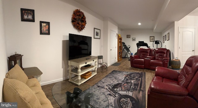 living room with recessed lighting, baseboards, and wood finished floors