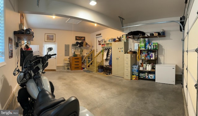 garage with electric panel and refrigerator