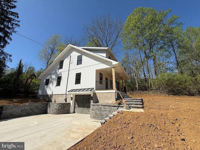 159 Rudloff Ln, Mohnton, PA 19540 - view of home's exterior featuring a standing seam roof, stairs, concrete driveway, an attached garage, and board and batten siding