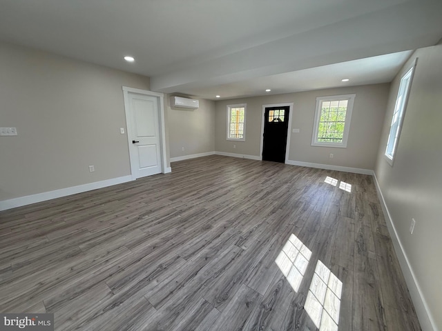 159 Rudloff Ln, Mohnton, PA 19540 - unfurnished living room with a wall mounted AC, wood finished floors, recessed lighting, and baseboards