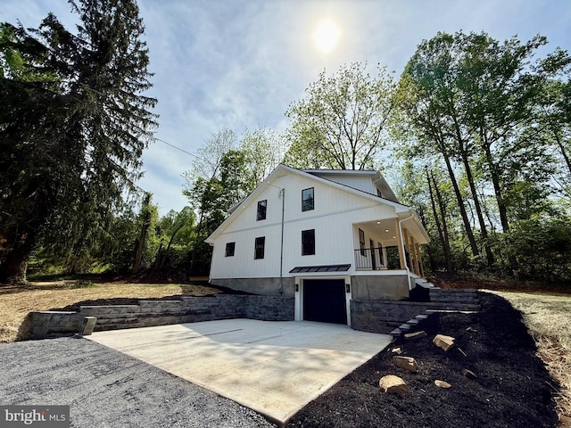 159 Rudloff Ln, Mohnton, PA 19540 - view of side of home featuring driveway, a garage, a standing seam roof, metal roof, and stairs