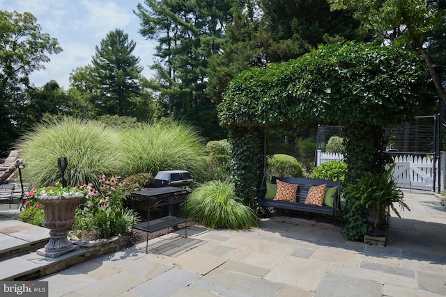 view of patio / terrace with fence, grilling area, and a gate