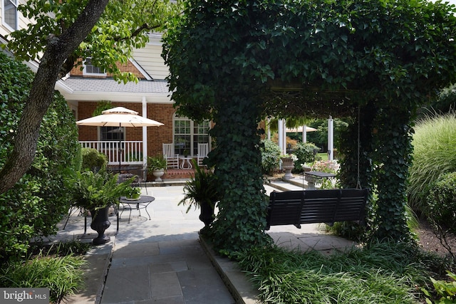 exterior space featuring concrete driveway and a patio area