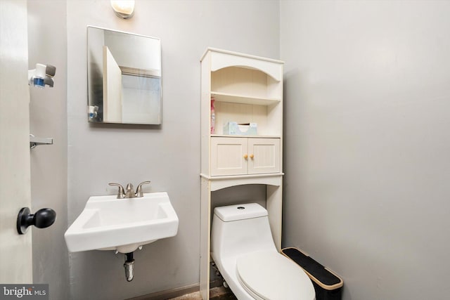 half bath with a sink and toilet
