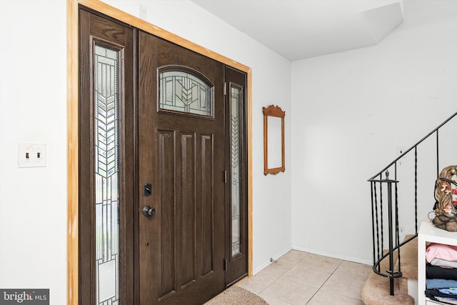 entryway with light tile patterned floors and baseboards