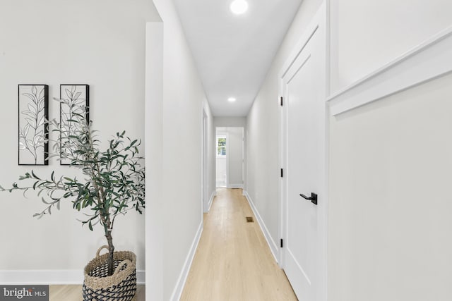 hall featuring recessed lighting, light wood-style flooring, and baseboards