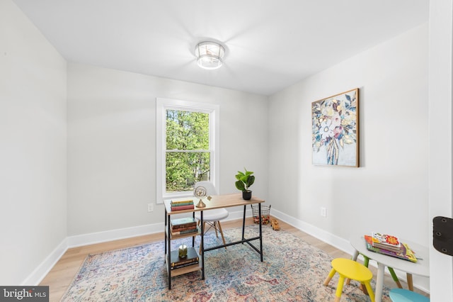 office with baseboards and light wood-type flooring