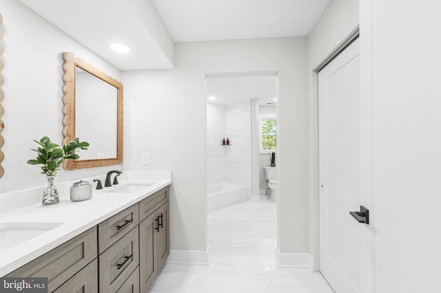 full bath with double vanity, a sink, recessed lighting, and toilet