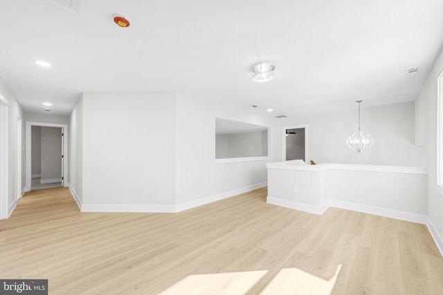spare room with recessed lighting, baseboards, light wood-type flooring, and visible vents