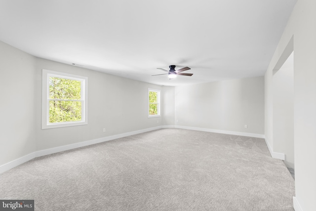 unfurnished room with carpet floors, baseboards, and ceiling fan