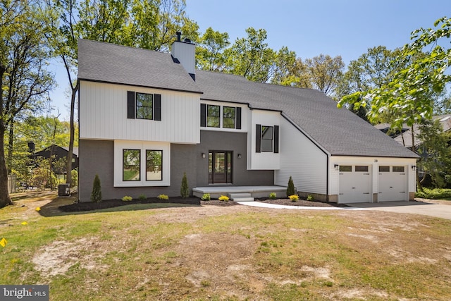 modern inspired farmhouse featuring a garage, a front yard, roof with shingles, a chimney, and concrete driveway