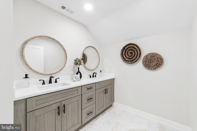 full bathroom featuring visible vents, lofted ceiling, a sink, and marble finish floor